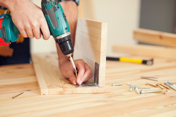 close-up-carpenter-working-with-drill